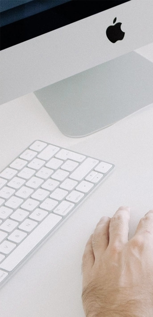Consultant working at a desk with a keyboard and monitor
