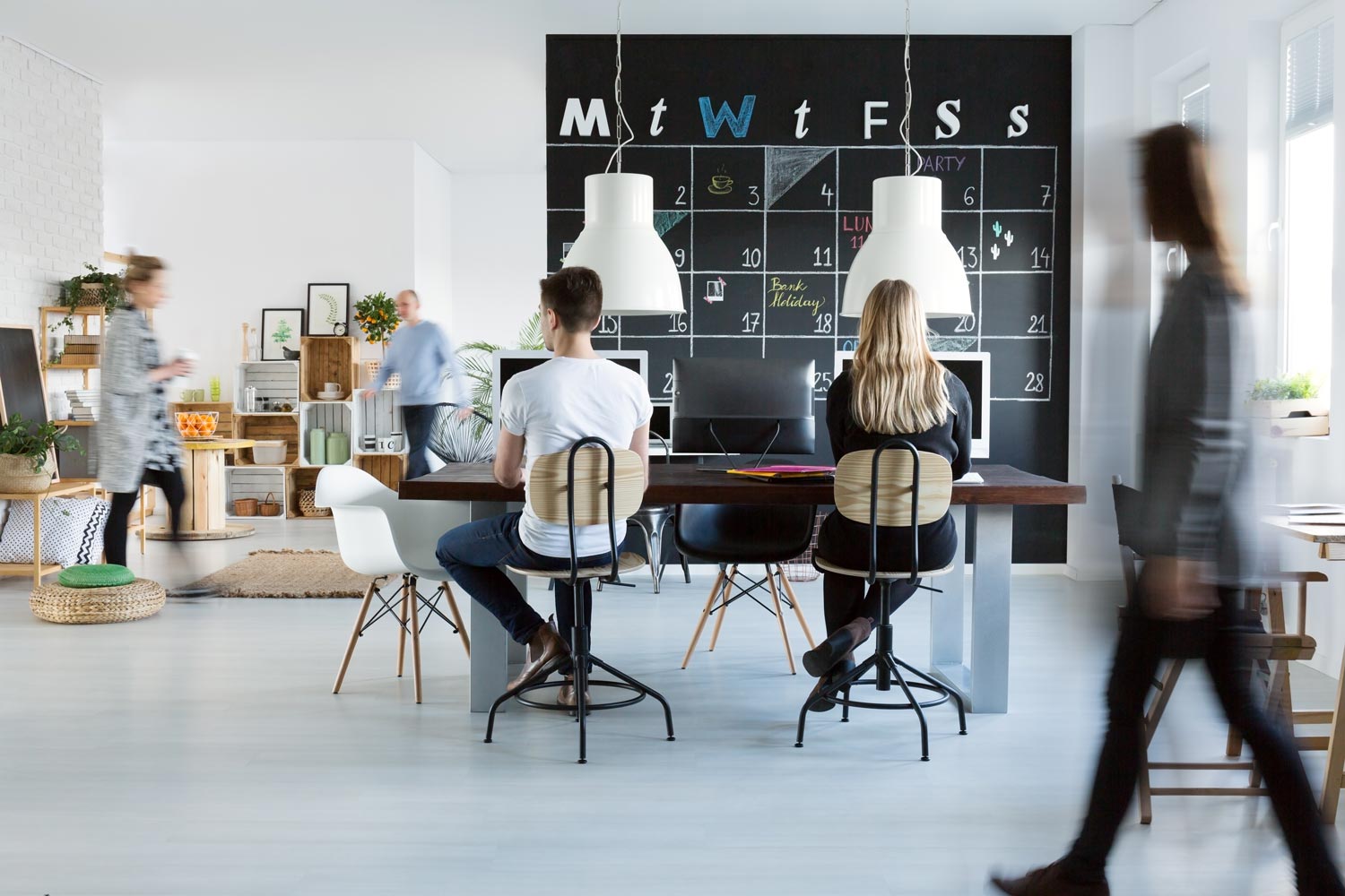 Recruitment team collaborating around a table in an open-plan office